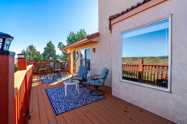 wooden terrace featuring outdoor dining space