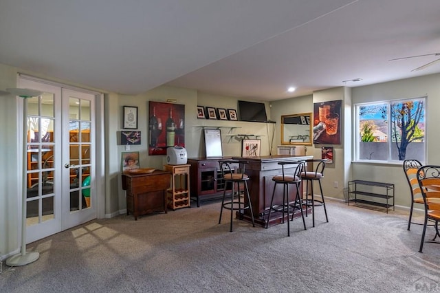 bar with carpet, french doors, recessed lighting, a bar, and baseboards