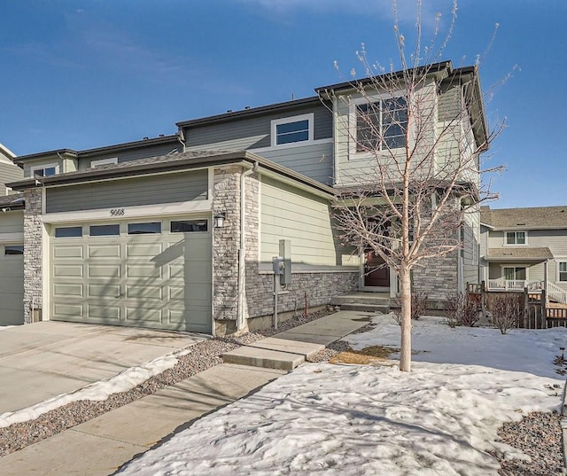 view of front of property featuring driveway and stone siding