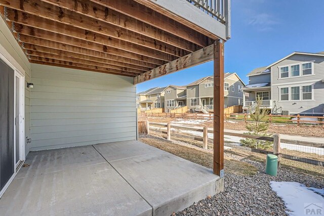 view of patio / terrace with a residential view and fence