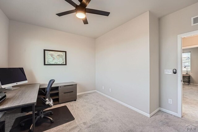 home office featuring ceiling fan, baseboards, and light colored carpet