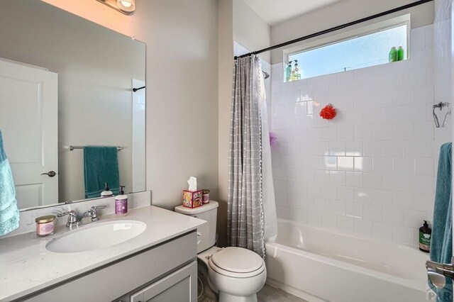 bathroom with toilet, shower / bath combo with shower curtain, and vanity