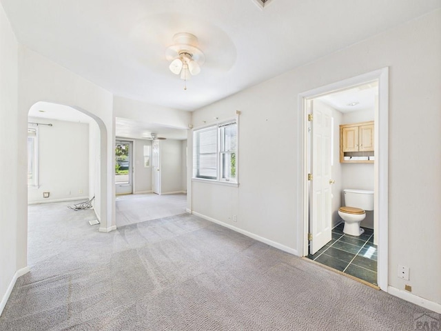 705 Euclid Ave, Pueblo, CO 81004 - carpeted empty room with ceiling fan and arched walkways