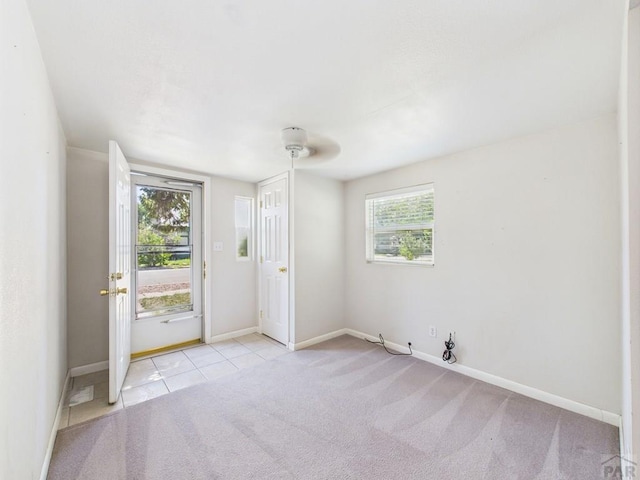 705 Euclid Ave, Pueblo, CO 81004 - carpeted spare room with baseboards and tile patterned floors