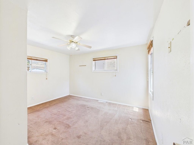 705 Euclid Ave, Pueblo, CO 81004 - empty room with carpet flooring, healthy amount of natural light, and a ceiling fan