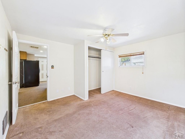 705 Euclid Ave, Pueblo, CO 81004 - unfurnished bedroom with fridge, carpet flooring, a closet, and a ceiling fan