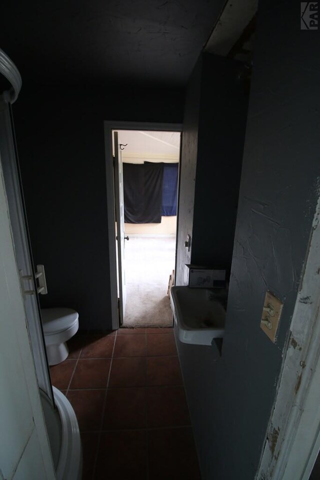 bathroom featuring toilet and tile patterned floors