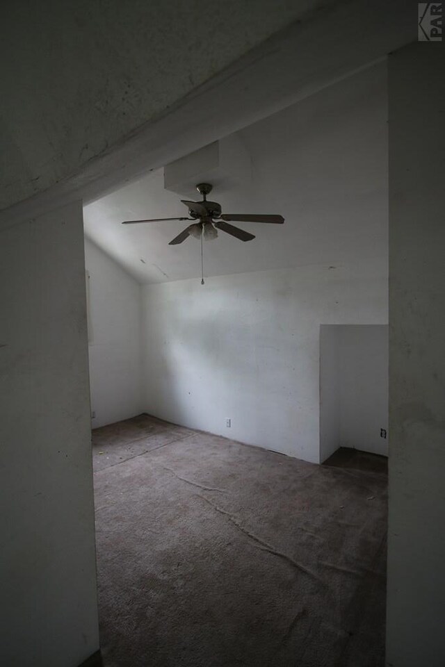 additional living space with carpet flooring, vaulted ceiling with beams, and ceiling fan