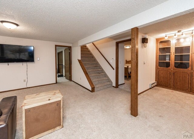 11210 Eggar Dr, Peyton, CO 80831 - finished basement with carpet floors, baseboards, stairway, and a textured ceiling