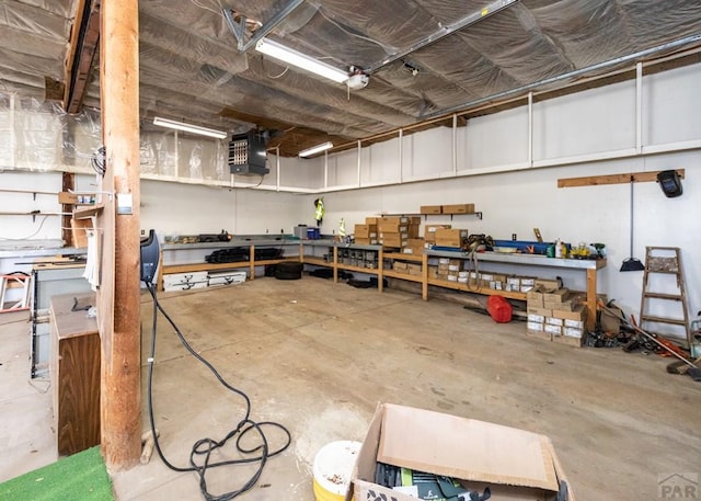 11210 Eggar Dr, Peyton, CO 80831 - garage featuring a garage door opener and a workshop area