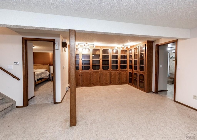 11210 Eggar Dr, Peyton, CO 80831 - wine area featuring baseboards, a textured ceiling, and light carpet