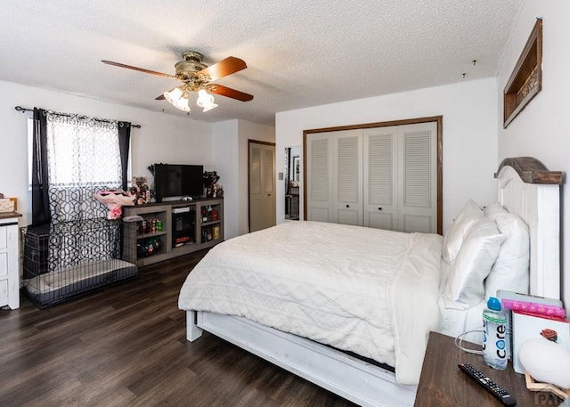 11210 Eggar Dr, Peyton, CO 80831 - bedroom with a textured ceiling, dark wood-style flooring, a ceiling fan, and two closets