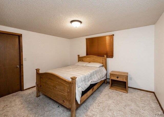 11210 Eggar Dr, Peyton, CO 80831 - bedroom featuring light carpet, baseboards, and a textured ceiling