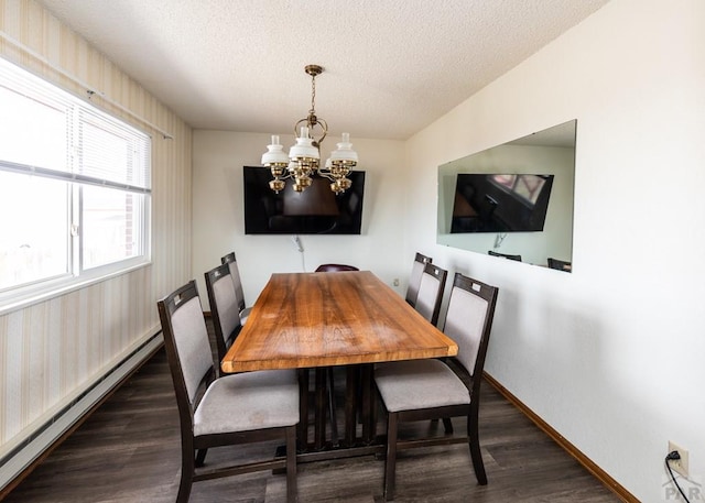 11210 Eggar Dr, Peyton, CO 80831 - dining area featuring a baseboard radiator, a notable chandelier, dark wood-type flooring, and a textured ceiling