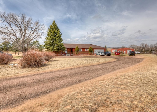 11210 Eggar Dr, Peyton, CO 80831 - view of front facade with dirt driveway and an attached garage
