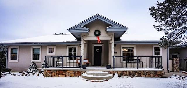 view of front of house with covered porch and stucco siding