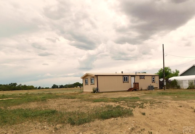 back of house featuring central AC