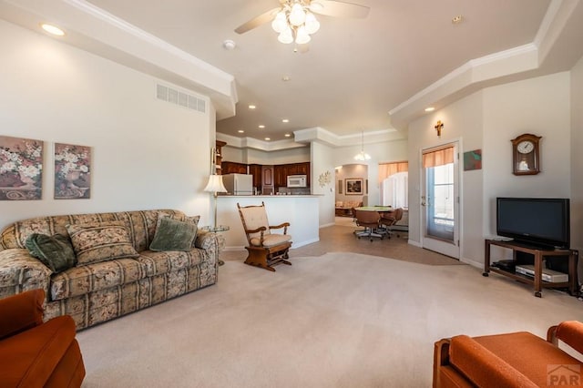 living room with visible vents, crown molding, light carpet, and baseboards