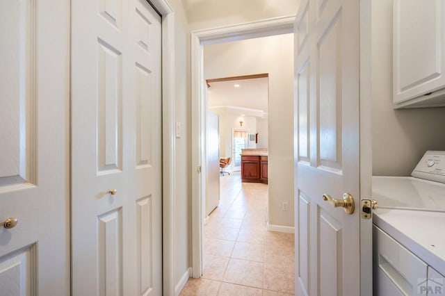 washroom featuring cabinet space, light tile patterned floors, and separate washer and dryer