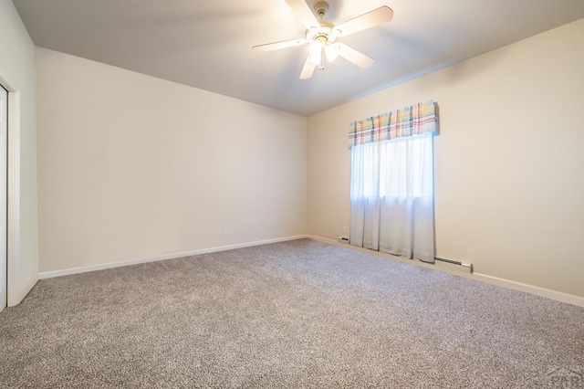 unfurnished room with carpet, a ceiling fan, and baseboards