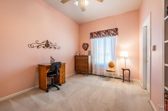 office area with baseboards, a ceiling fan, and light colored carpet