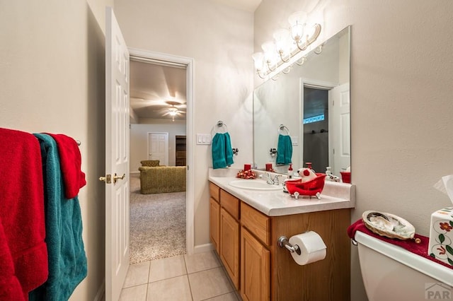 bathroom featuring tile patterned flooring, vanity, and toilet