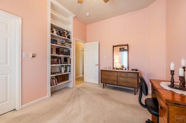 office area featuring baseboards, a ceiling fan, and light colored carpet