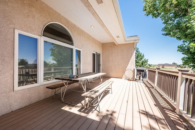 wooden terrace featuring outdoor dining area