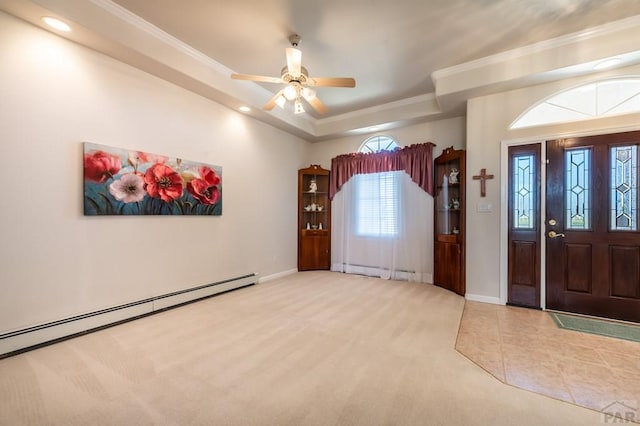 carpeted foyer featuring a tray ceiling, baseboards, crown molding, and baseboard heating