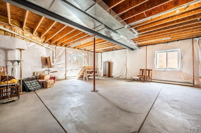 basement with a wealth of natural light and a baseboard radiator