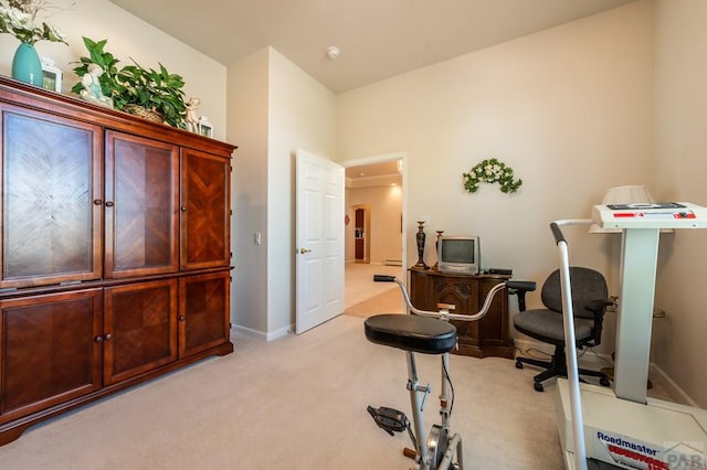 office space featuring light carpet and baseboards