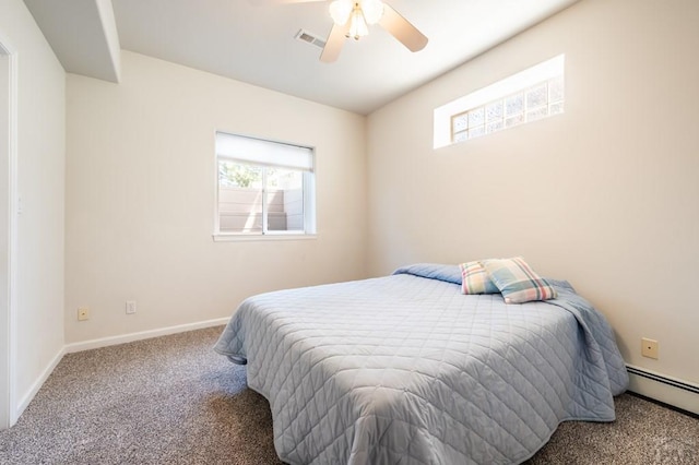 carpeted bedroom with visible vents, multiple windows, baseboards, and baseboard heating