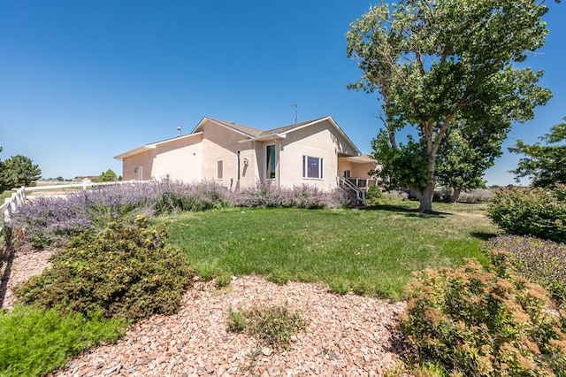 view of front of house featuring a front yard and stucco siding