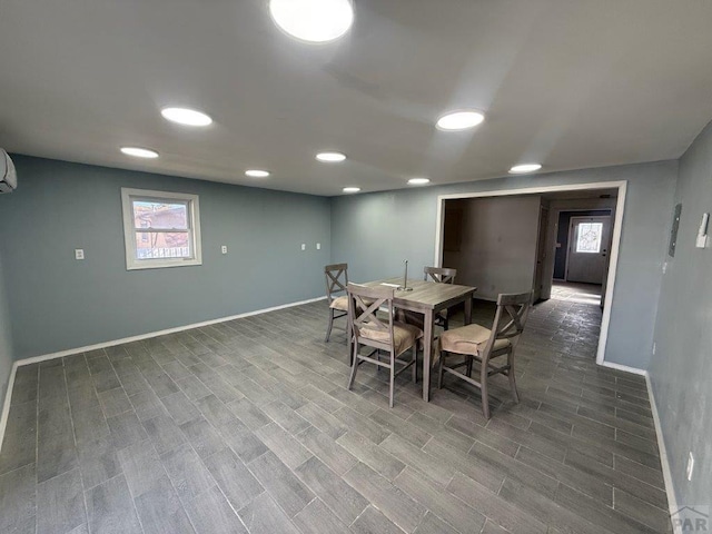 dining room featuring a healthy amount of sunlight, wood finished floors, and baseboards
