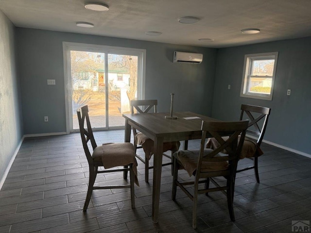 dining area with a healthy amount of sunlight, dark wood-style floors, baseboards, and an AC wall unit