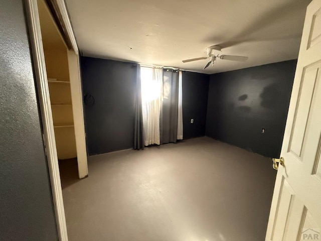 unfurnished bedroom featuring finished concrete flooring and ceiling fan