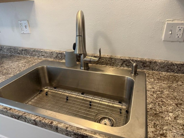 details featuring dark countertops and a sink
