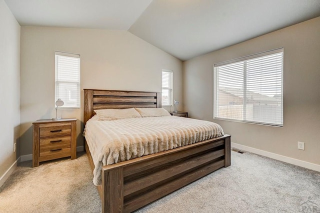 bedroom with lofted ceiling, light carpet, visible vents, and baseboards