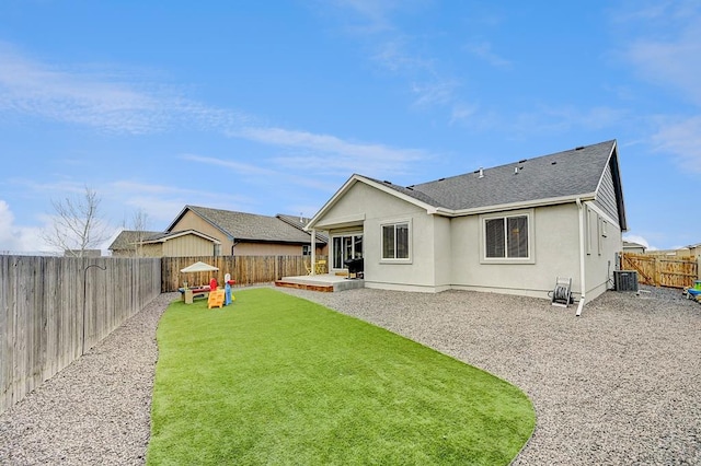 rear view of house featuring a patio, a fenced backyard, a shingled roof, a yard, and stucco siding