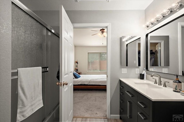 4315 Outlook Blvd Unit L, Pueblo, CO 81008 - ensuite bathroom featuring vanity, wood finished floors, ceiling fan, a shower with shower door, and a closet