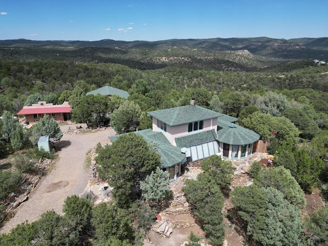 birds eye view of property with a forest view and a mountain view