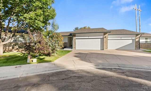 view of front of house with concrete driveway and an attached garage