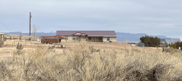 view of front of property featuring a rural view and a mountain view