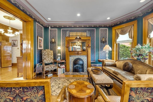 326 W Pitkin Ave, Pueblo, CO 81004 - living area with ornamental molding, wallpapered walls, wood finished floors, a tile fireplace, and a chandelier