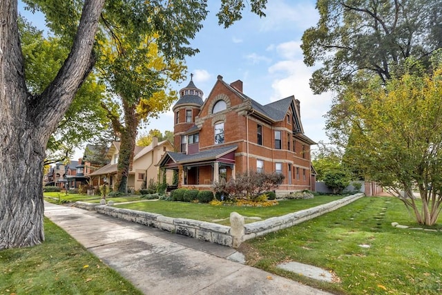 326 W Pitkin Ave, Pueblo, CO 81004 - view of home's exterior with a lawn, a chimney, and brick siding