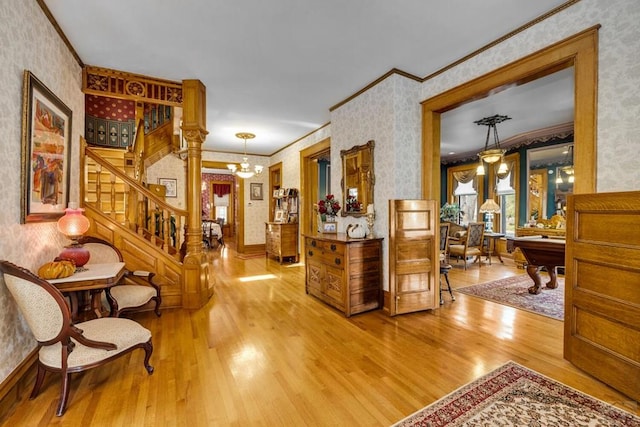 326 W Pitkin Ave, Pueblo, CO 81004 - entrance foyer featuring wallpapered walls, ornamental molding, wood finished floors, stairs, and a chandelier