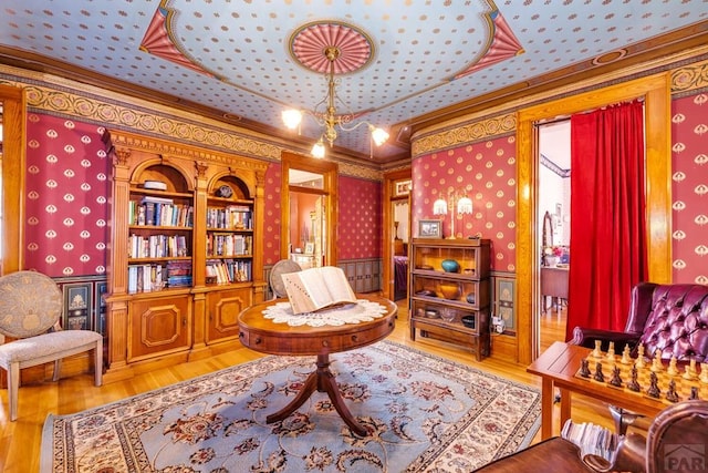 326 W Pitkin Ave, Pueblo, CO 81004 - living area featuring wallpapered walls, ornamental molding, and wood finished floors
