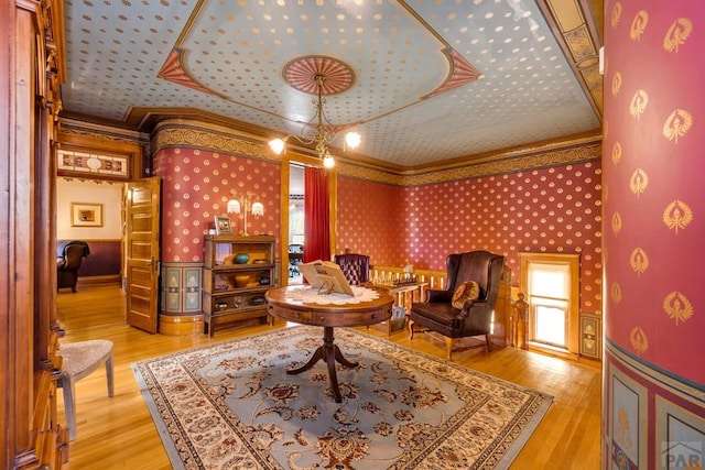 326 W Pitkin Ave, Pueblo, CO 81004 - sitting room featuring crown molding, wallpapered walls, wood finished floors, and a raised ceiling