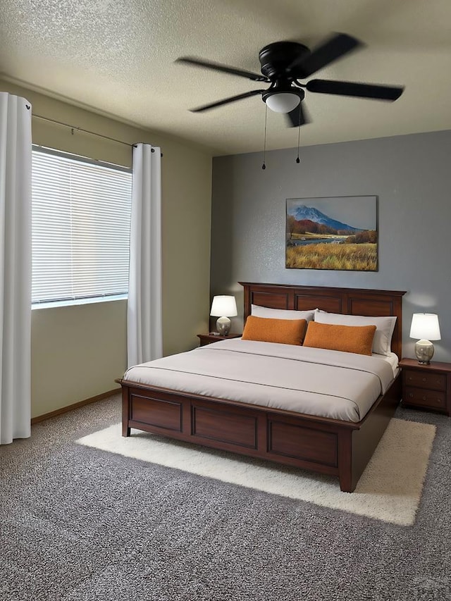 bedroom featuring a textured ceiling, carpet floors, ceiling fan, and baseboards