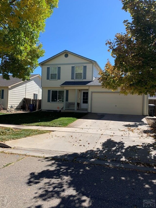 traditional home featuring driveway and an attached garage